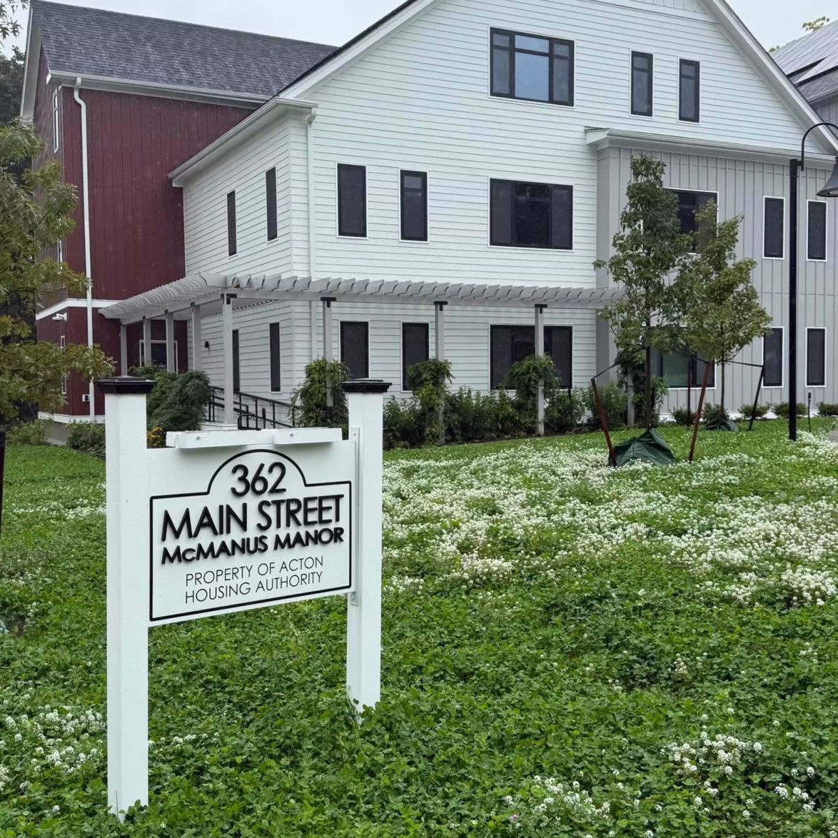 Sign reading 362 Main Street McManus Manor, property of Acton Housing Authority, in front of the senior apartment building
