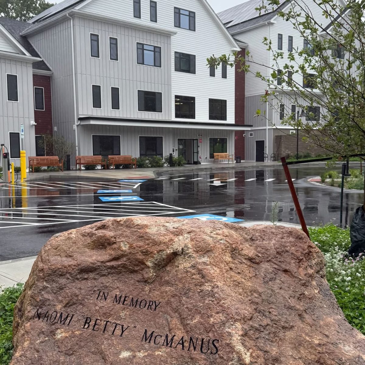 Memorial stone honoring Naomi "Betty" McManus in front of McManus Manor senior apartments building