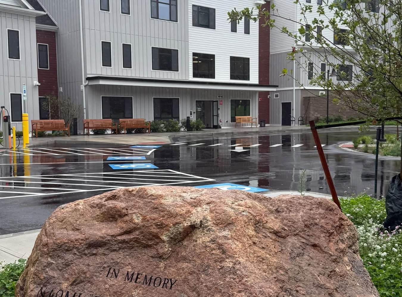 Memorial stone honoring Naomi "Betty" McManus in front of McManus Manor senior apartments building